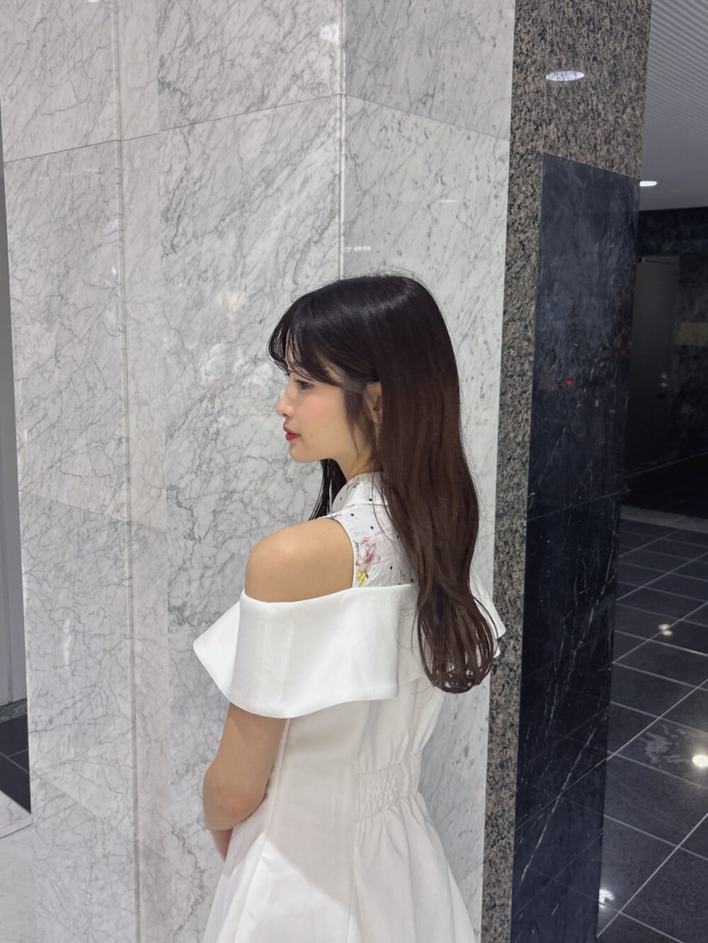 ホワイト系のサンダル、ホワイト系のワンピース、ホワイト系のかごバッグを着用したレディースの夏コーディネートの6枚目の写真