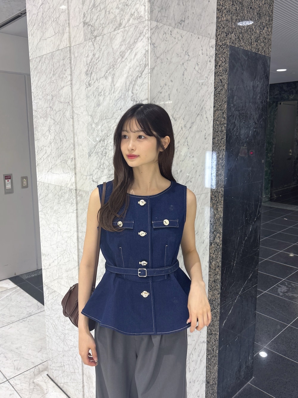 グレー系のその他パンツ、ブルー系のベスト、ブラウン系のサンダルを着用したレディースの夏コーディネートの4枚目の写真