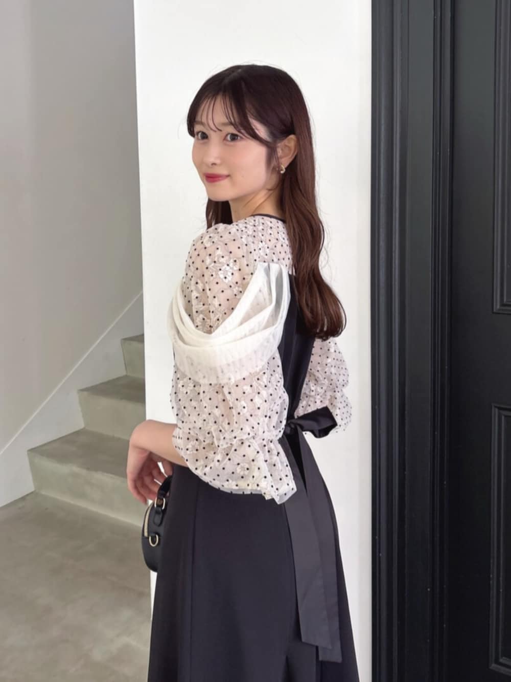 ブラック系のパンプス、ブラック系のドレスを着用したレディースの夏コーディネートの6枚目の写真
