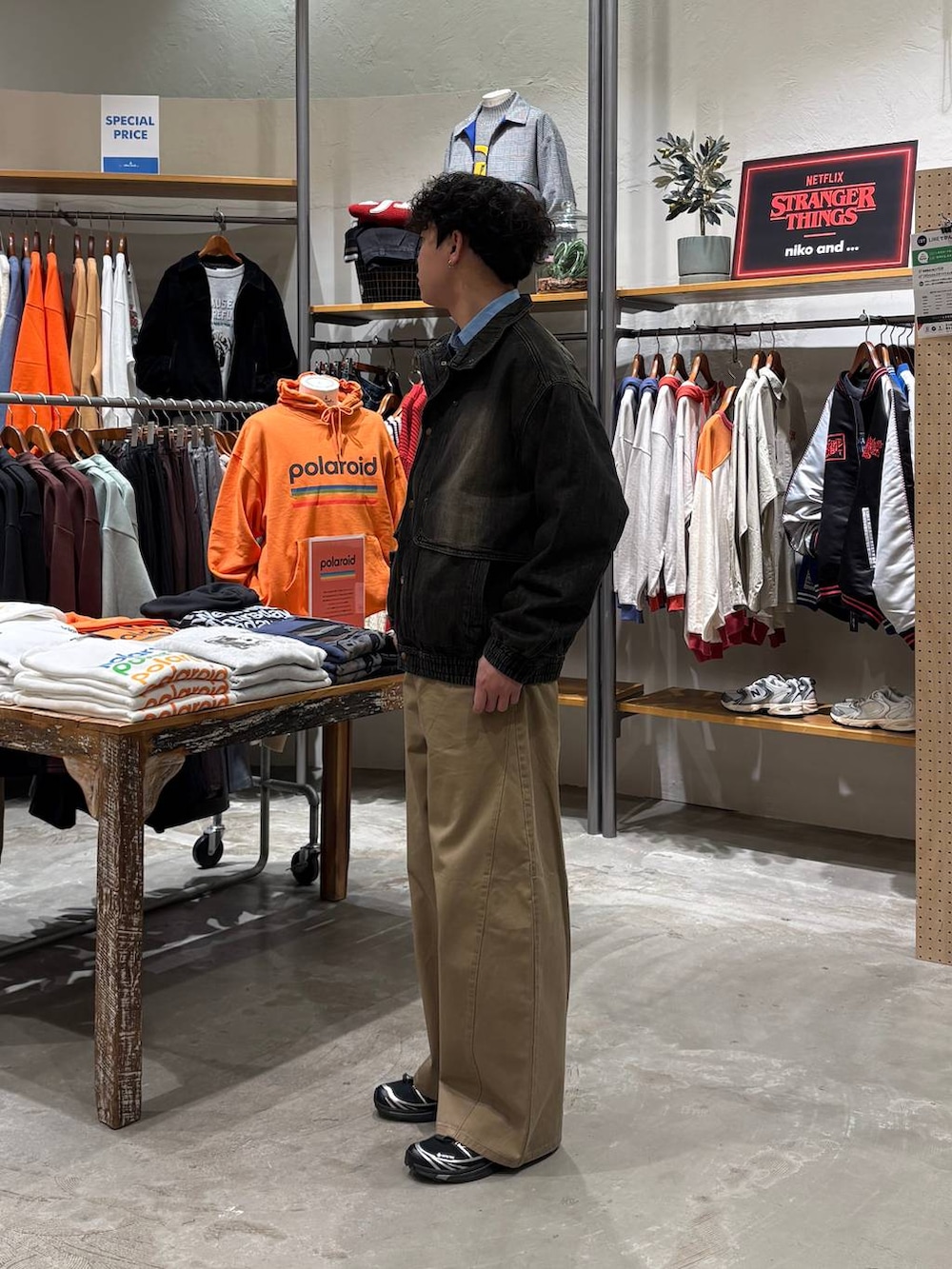 グレー系のブルゾン、ベージュ系のチノパンツを着用したメンズの冬コーディネートの4枚目の写真