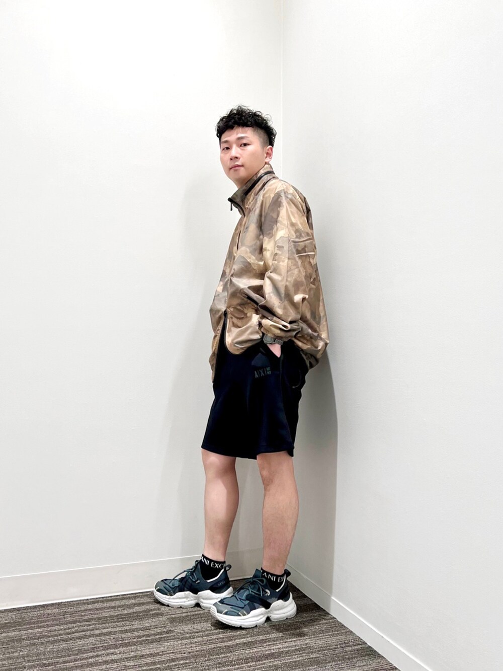 グリーン系のブルゾン、ブラック系のその他パンツ、グレー系のスニーカーを着用したメンズの夏コーディネートの2枚目の写真