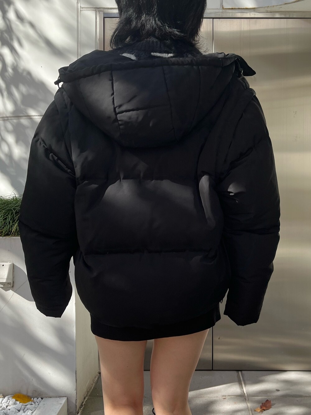 ブラック系のダウンジャケット/コート、ブラック系のニット/セーター、ブラック系のスカートを着用したレディースの冬コーディネートの6枚目の写真