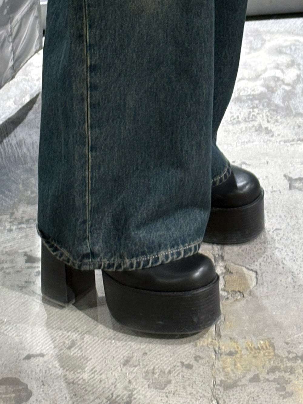 ブラック系のニット/セーター、ブルー系のデニムパンツ、ブラック系のブーツを着用したレディースの冬コーディネートの6枚目の写真