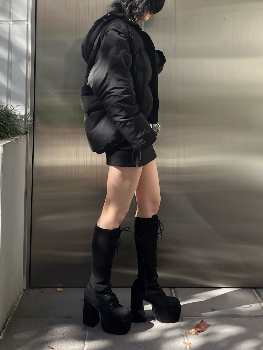 ブラック系のダウンジャケット/コート、ブラック系のニット/セーター、ブラック系のスカートを着用したレディースの冬コーディネートの2枚目の写真