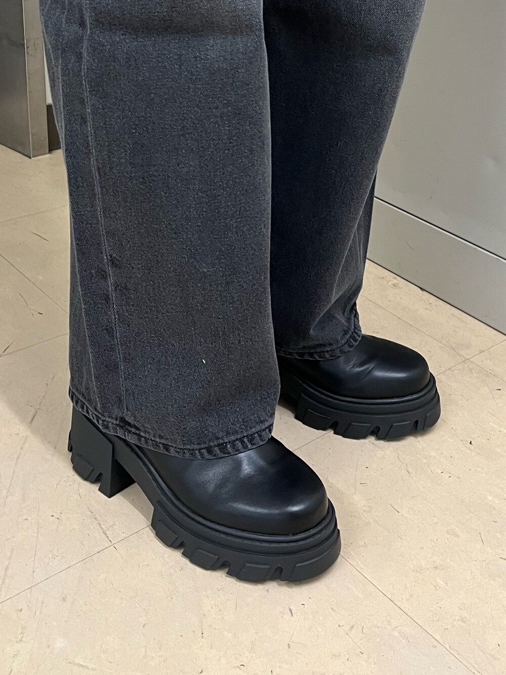 ブラック系のニット/セーター、その他のチェスターコート、グレー系のデニムパンツを着用したレディースの冬コーディネートの8枚目の写真