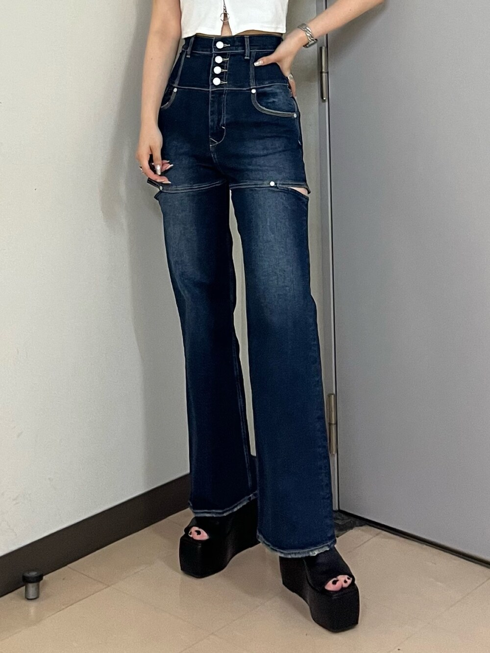 ホワイト系のTシャツ/カットソー、ブルー系のデニムパンツ、ブラック系のサンダルを着用したレディースの春コーディネートの6枚目の写真