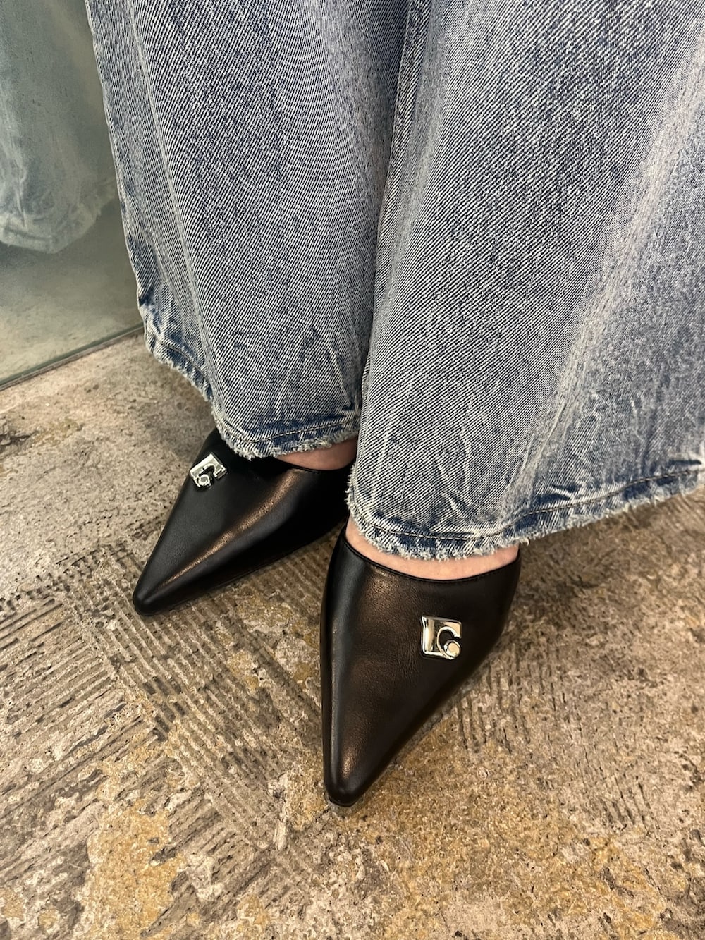 ホワイト系のニット/セーター、ブルー系のデニムパンツ、ブラック系のパンプスを着用したレディースの春コーディネートの7枚目の写真