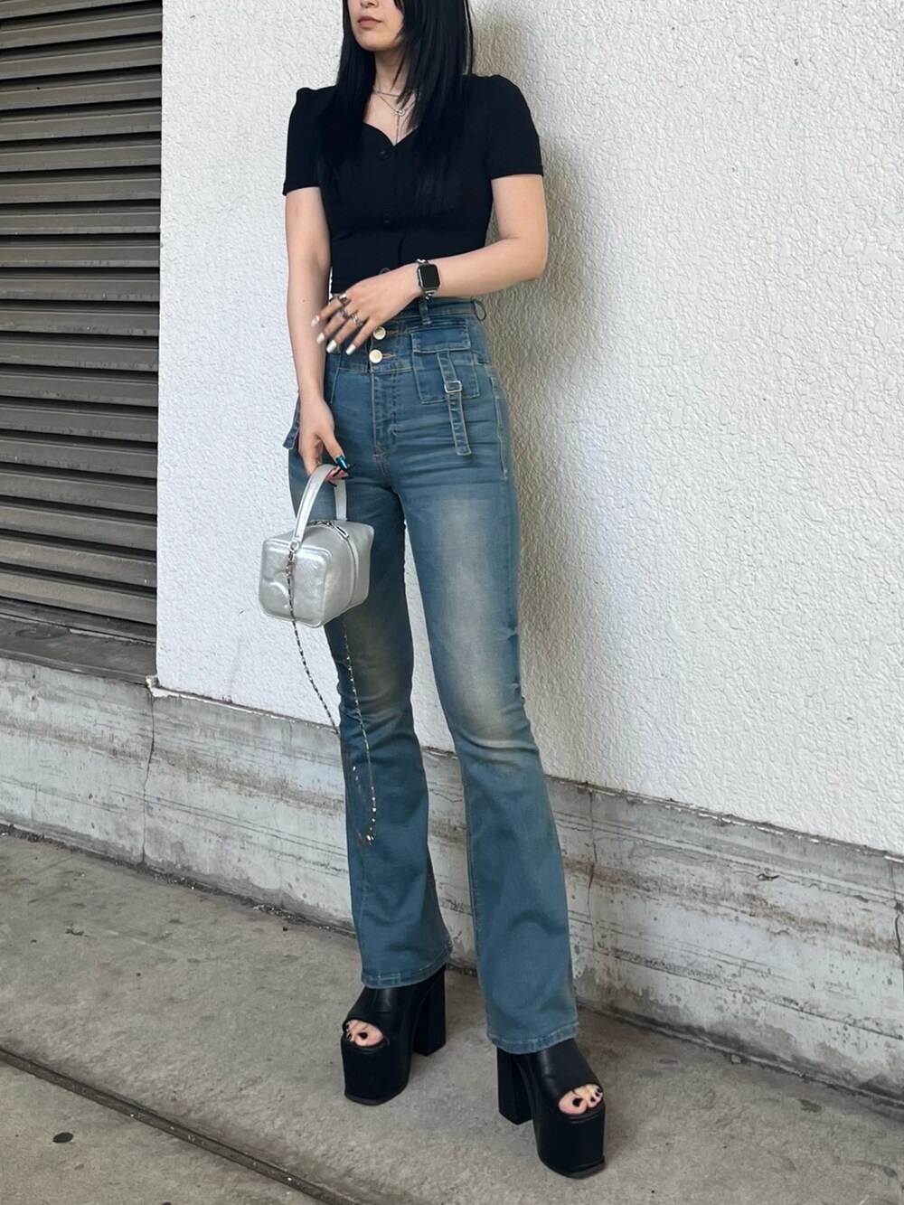 ブラック系のTシャツ/カットソー、ブルー系のデニムパンツ、シルバー系のハンドバッグを着用したレディースの夏コーディネートの2枚目の写真