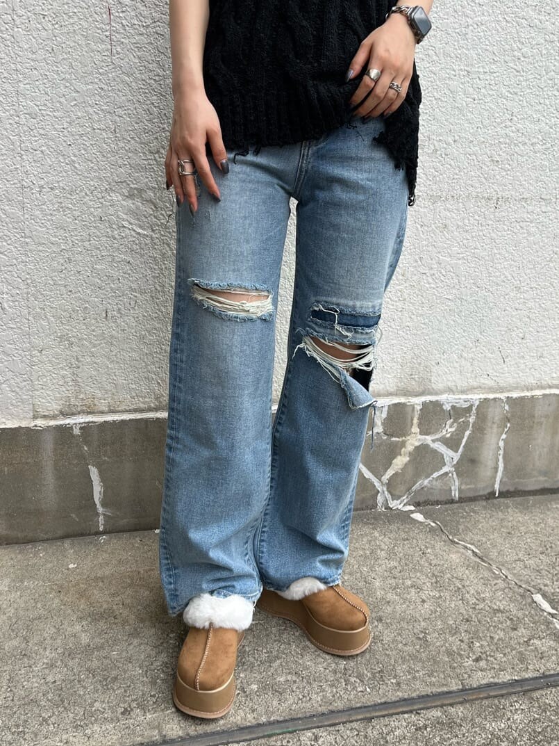 ブルー系のデニムパンツ、ベージュ系のスリッポン、ブラック系のベストを着用したレディースの秋コーディネートの7枚目の写真