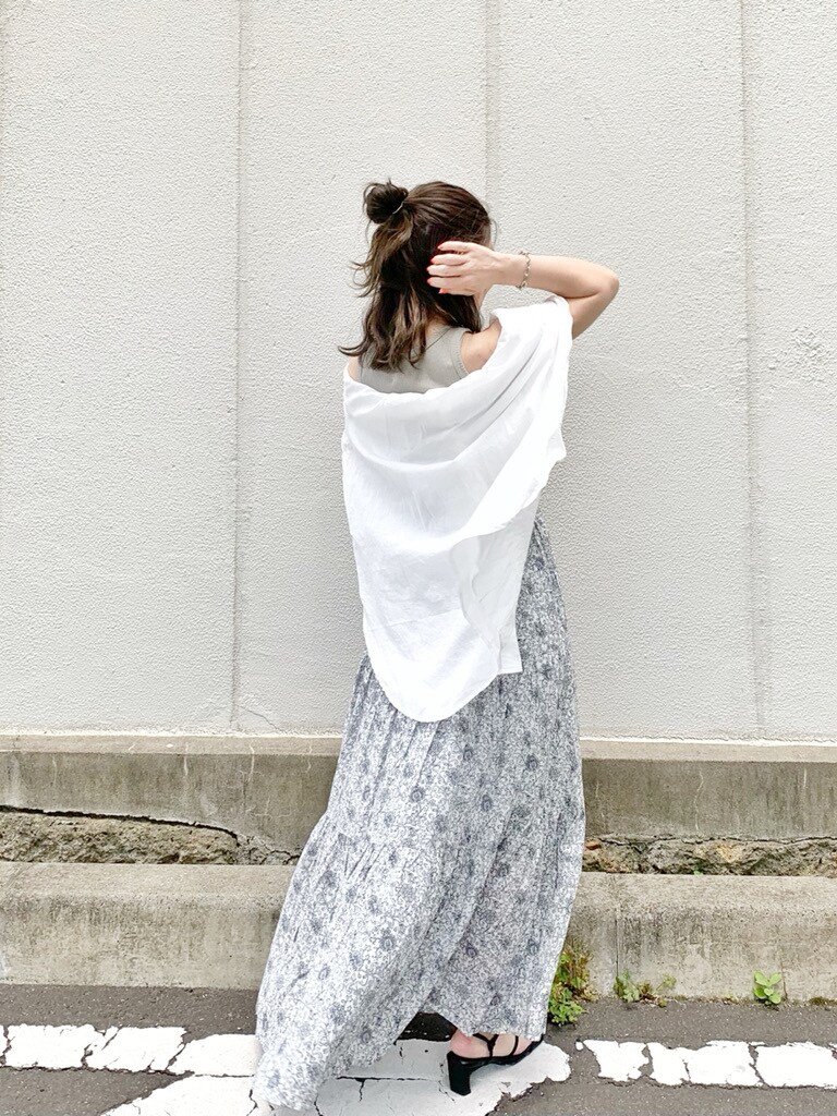 ベージュ系のTシャツ/カットソー、ホワイト系のシャツ/ブラウス、ホワイト系のスカートを着用したレディースの春コーディネートの3枚目の写真