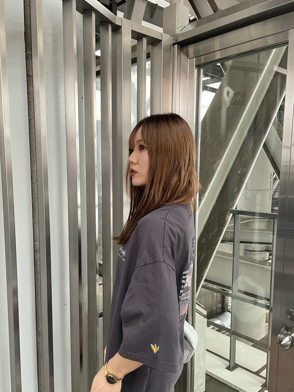 グレー系のTシャツ/カットソー、ホワイト系のハンドバッグを着用したレディースの春コーディネートの5枚目の写真