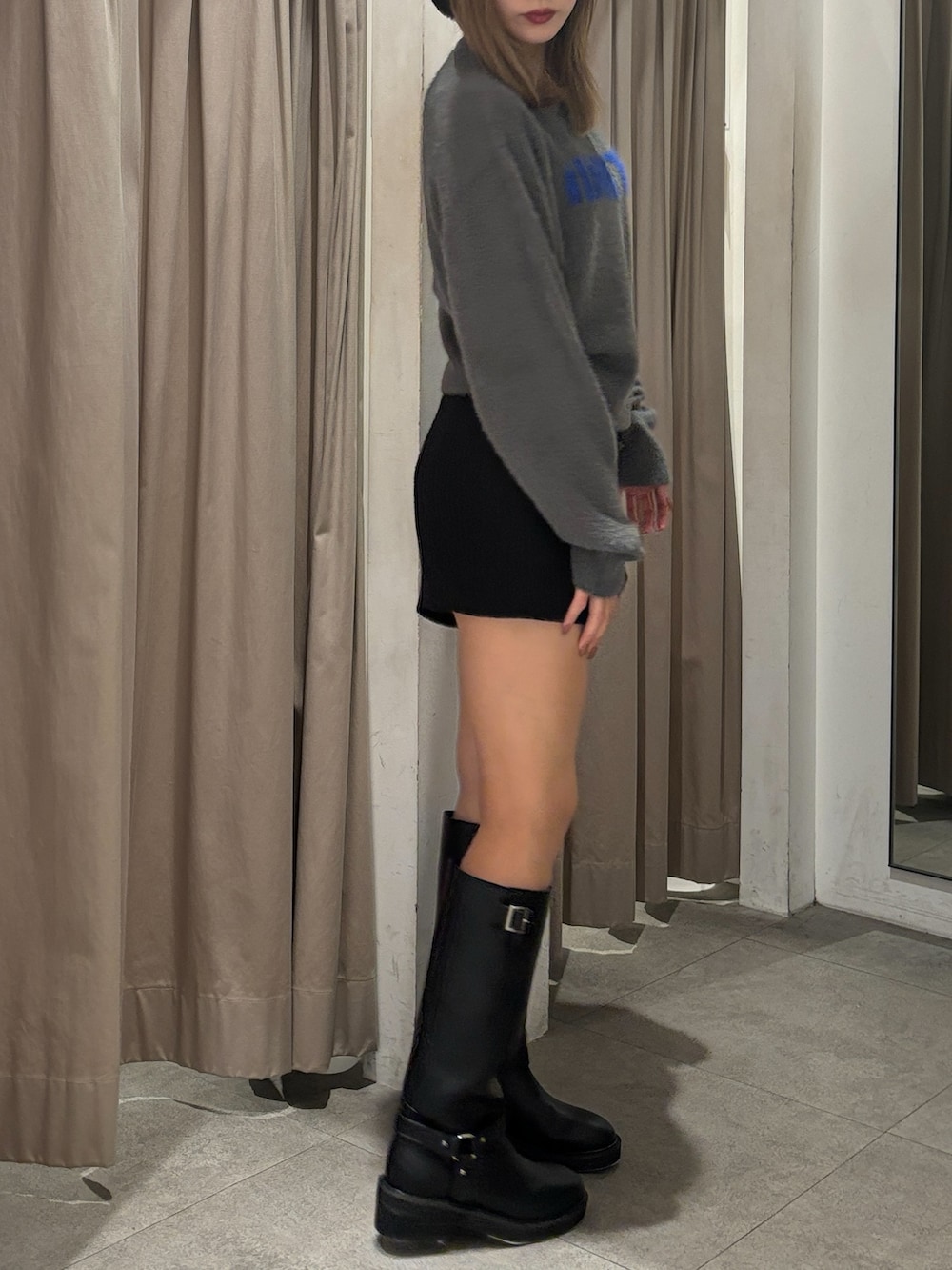 グレー系のニット/セーター、ブラック系のその他パンツ、ブラック系のブーツを着用したレディースの秋コーディネートの5枚目の写真