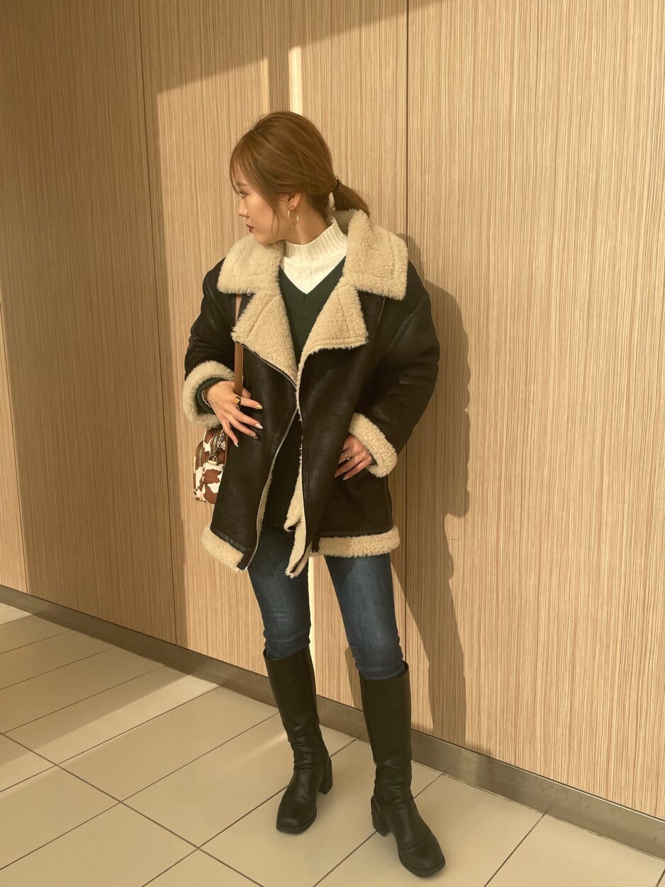その他のハンドバッグ、ブラック系のブルゾン、ブラック系のブーツを着用したレディースの冬コーディネートの2枚目の写真