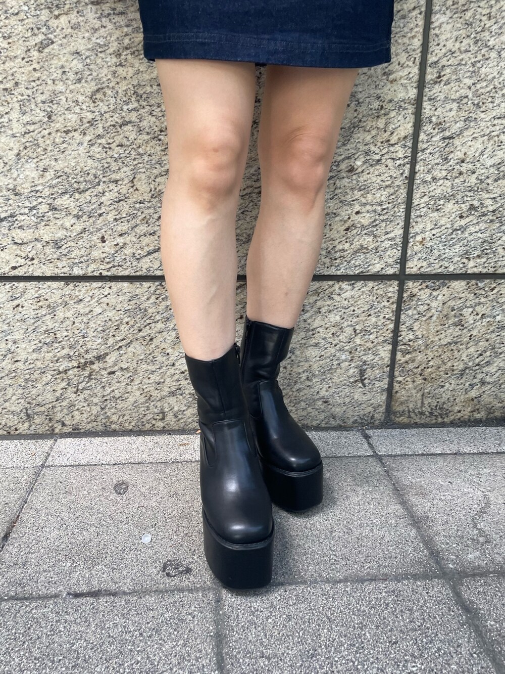 ベージュ系のニット/セーター、ブルー系のスカート、ブラック系のブーツを着用したレディースの夏コーディネートの10枚目の写真