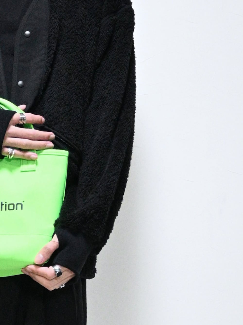 ブラック系のジャケット/アウター、グリーン系のトートバッグ、ブラック系のブーツを着用したメンズの冬コーディネートの2枚目の写真