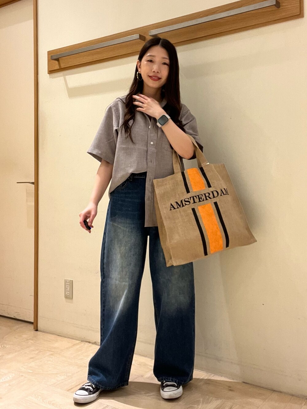 ベージュ系のシャツ/ブラウス、ブルー系のデニムパンツ、ブラック系のトートバッグを着用したレディースの夏コーディネートの2枚目の写真