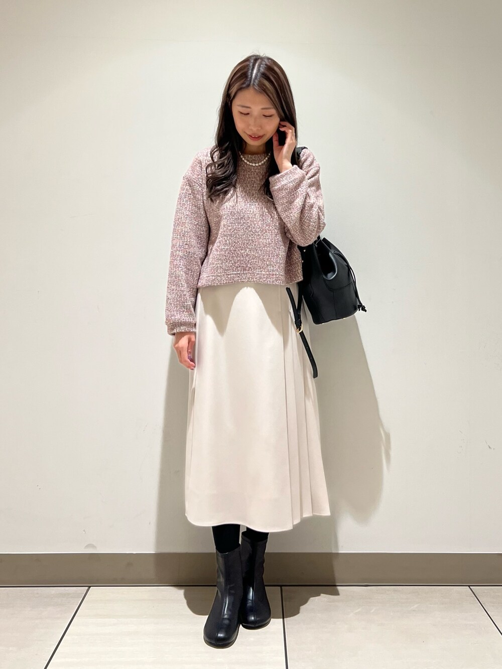 ホワイト系のスカート、パープル系のTシャツ/カットソーを着用したレディースの冬コーディネートの3枚目の写真