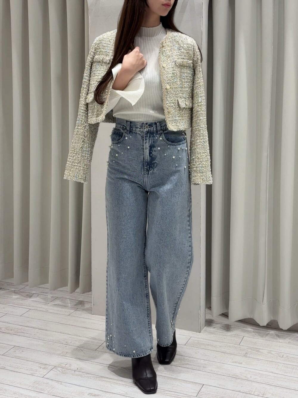 ブラウン系のブーツ、ホワイト系のニット/セーター、グリーン系のテーラードジャケットを着用したレディースの冬コーディネートの2枚目の写真