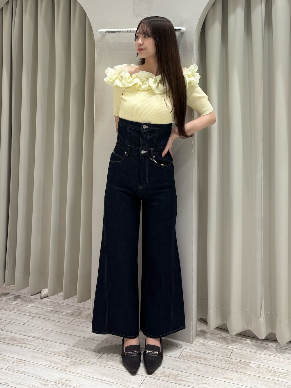 イエロー系のニット/セーター、ブルー系のその他パンツ、ブラウン系のパンプスを着用したレディースの春コーディネートの2枚目の写真