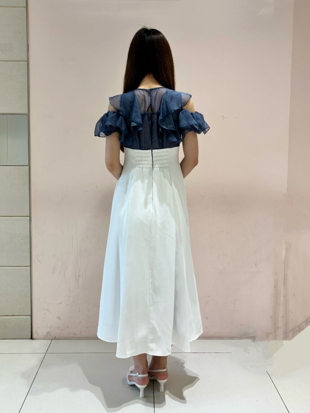 ホワイト系のワンピース、ホワイト系のショルダーバッグ、グレー系のパンプスを着用したレディースの夏コーディネートの5枚目の写真