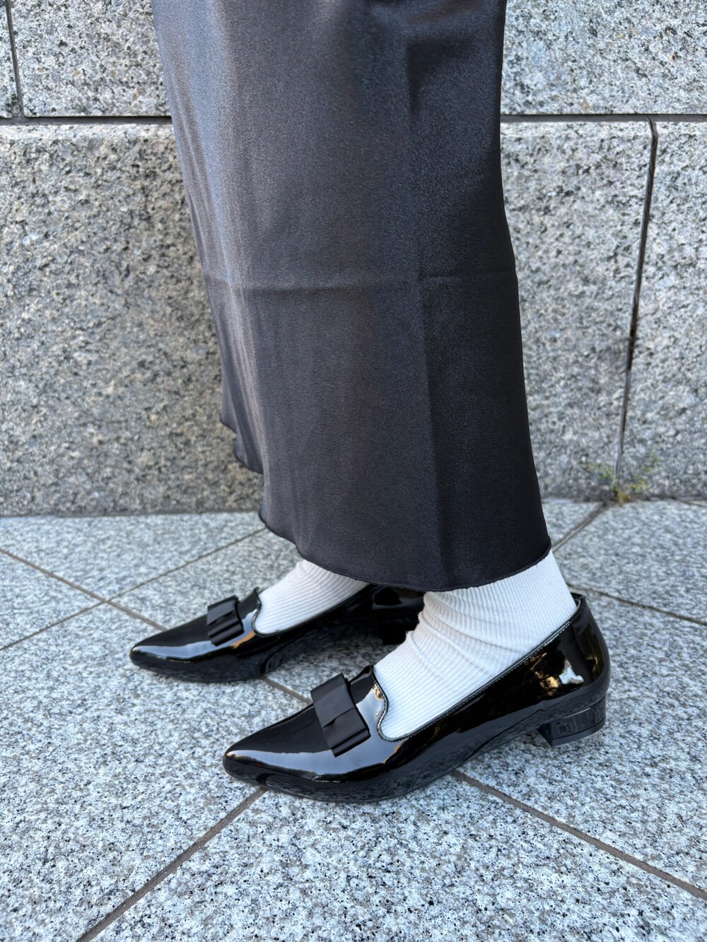 ブラック系のパンプスを着用したレディースの秋コーディネートの3枚目の写真