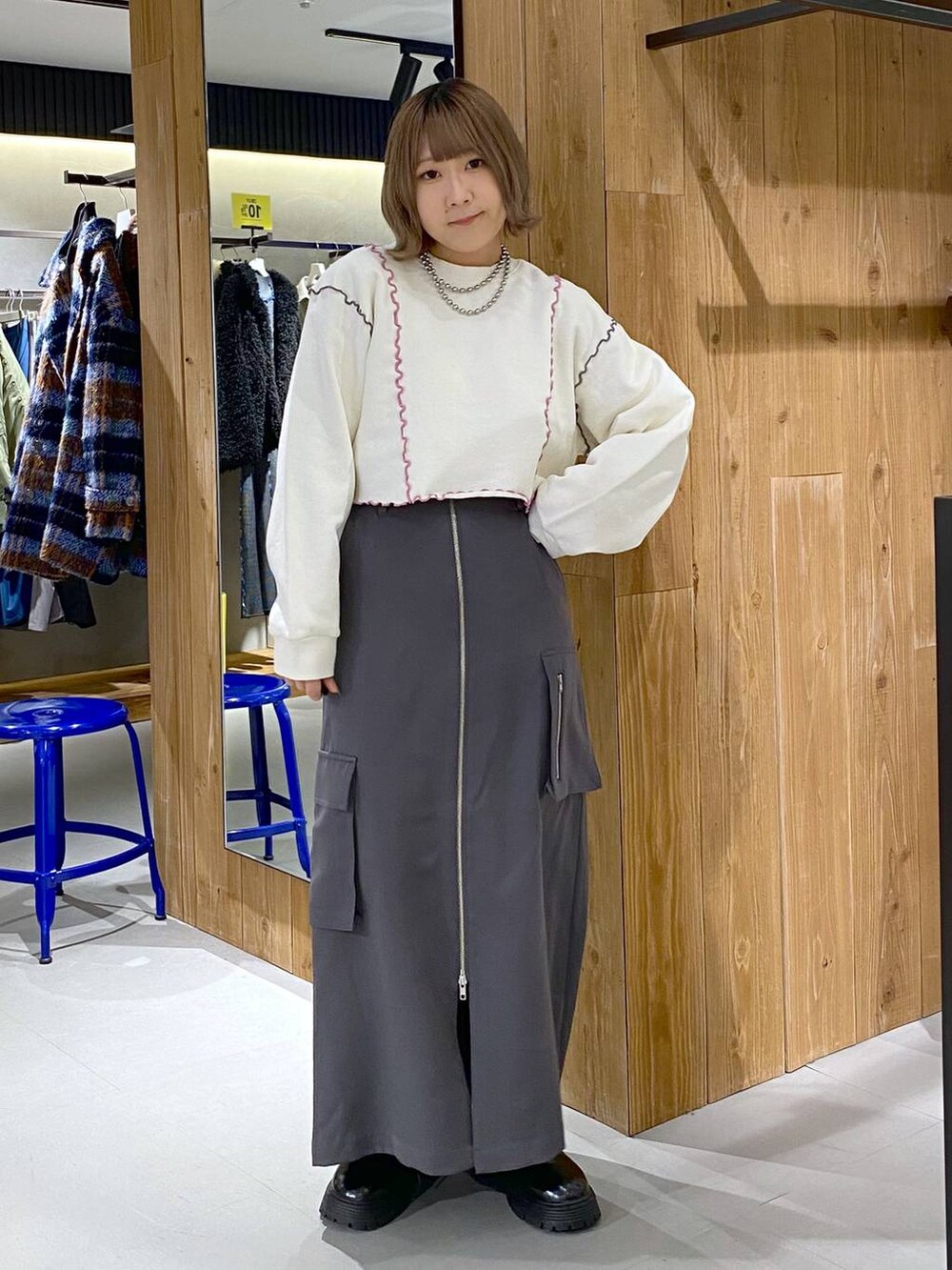 グレー系のスカート、ブラック系のその他シューズ、ホワイト系のTシャツ/カットソーを着用したレディースの冬コーディネートの4枚目の写真