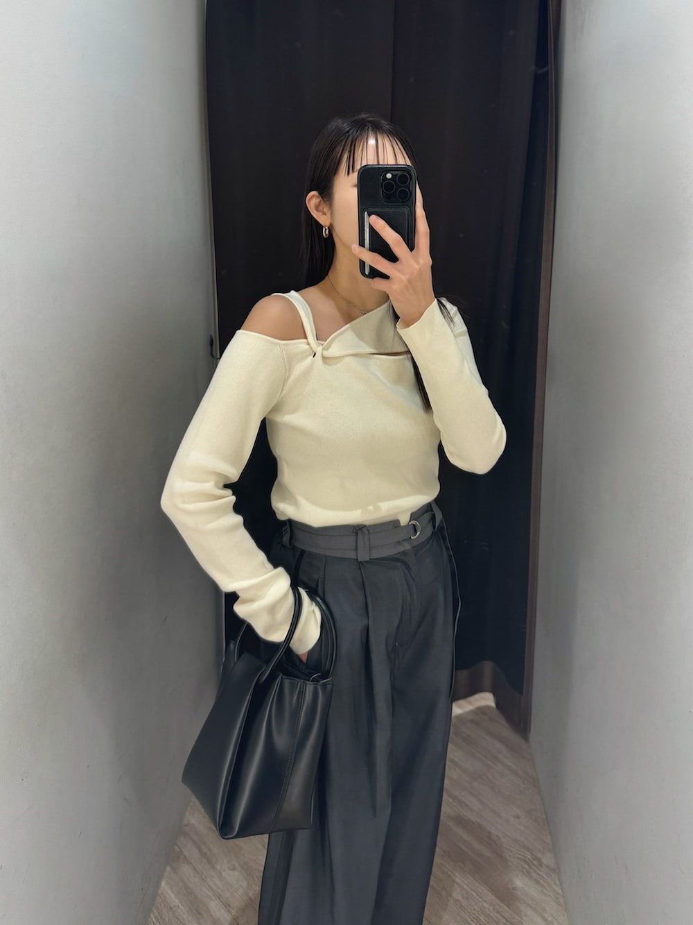 ホワイト系のニット/セーター、グレー系のその他パンツ、ブラック系のショルダーバッグを着用したレディースの冬コーディネートの2枚目の写真