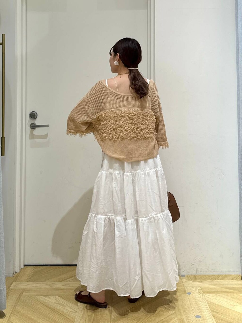 ホワイト系のワンピース、ブラウン系のサンダル、ブラウン系のショルダーバッグを着用したレディースの夏コーディネートの5枚目の写真