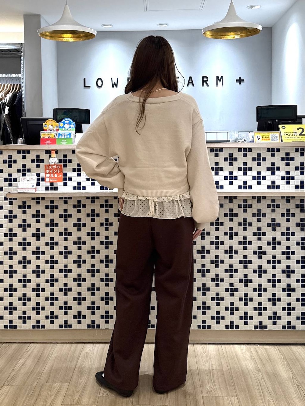 ホワイト系のカーディガン/ボレロ、ホワイト系のTシャツ/カットソー、ブラウン系のスウェットパンツを着用したレディースの秋コーディネートの6枚目の写真