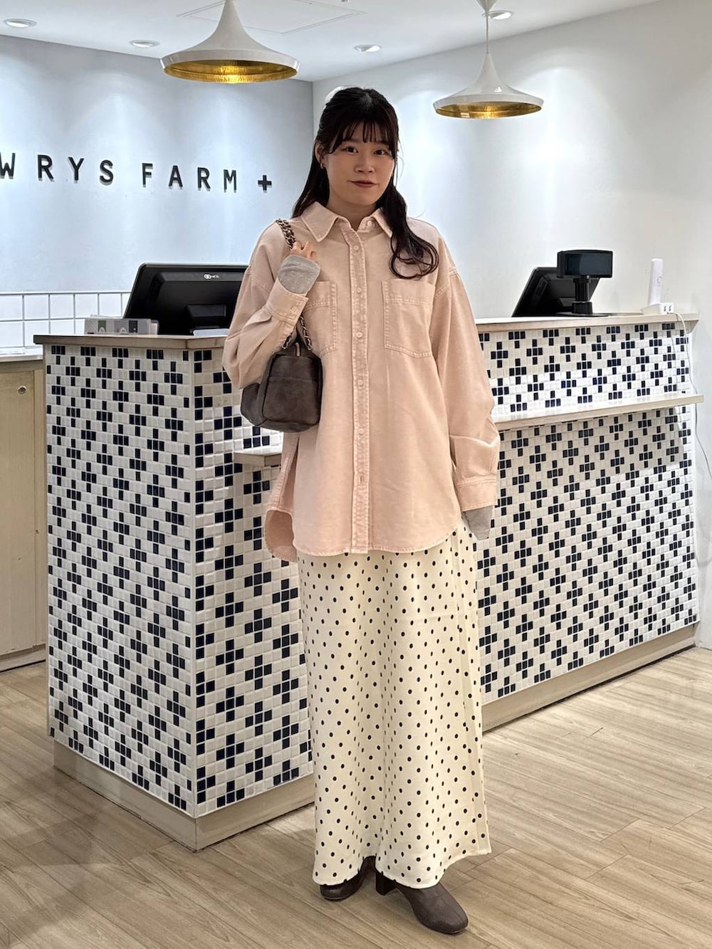 ホワイト系のスカート、ブラウン系のブーツ、ピンク系のシャツ/ブラウスを着用したレディースの冬コーディネートの5枚目の写真