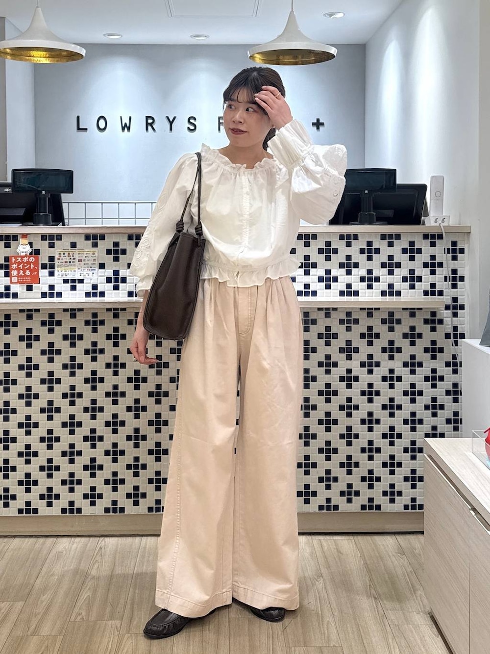 ピンク系のデニムパンツ、ブラウン系のローファー、ブラウン系のトートバッグを着用したレディースの春コーディネートの2枚目の写真