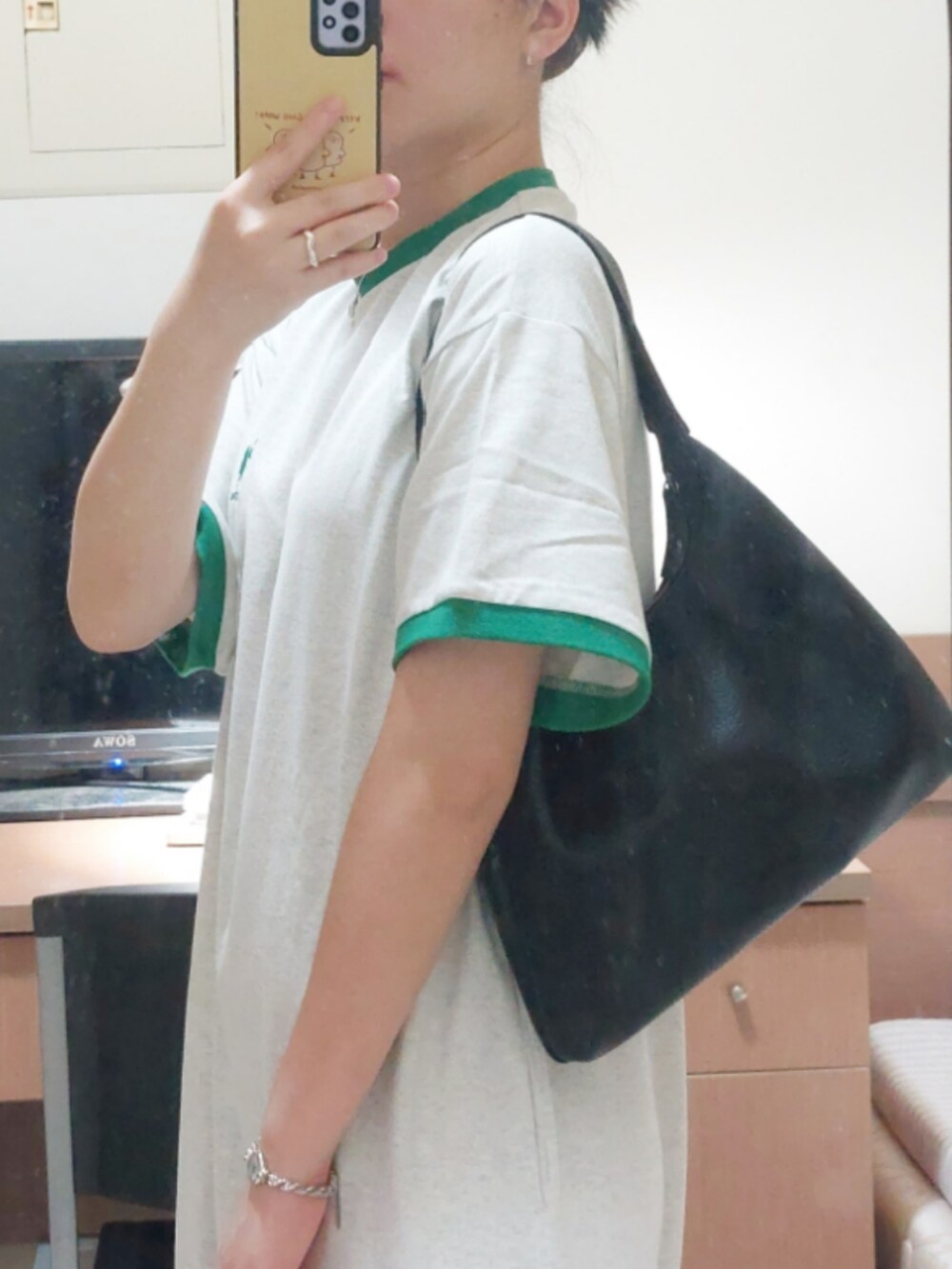 ベージュ系のワンピース、ブラック系のサンダル、ブラック系のショルダーバッグを着用したレディースの夏コーディネートの2枚目の写真