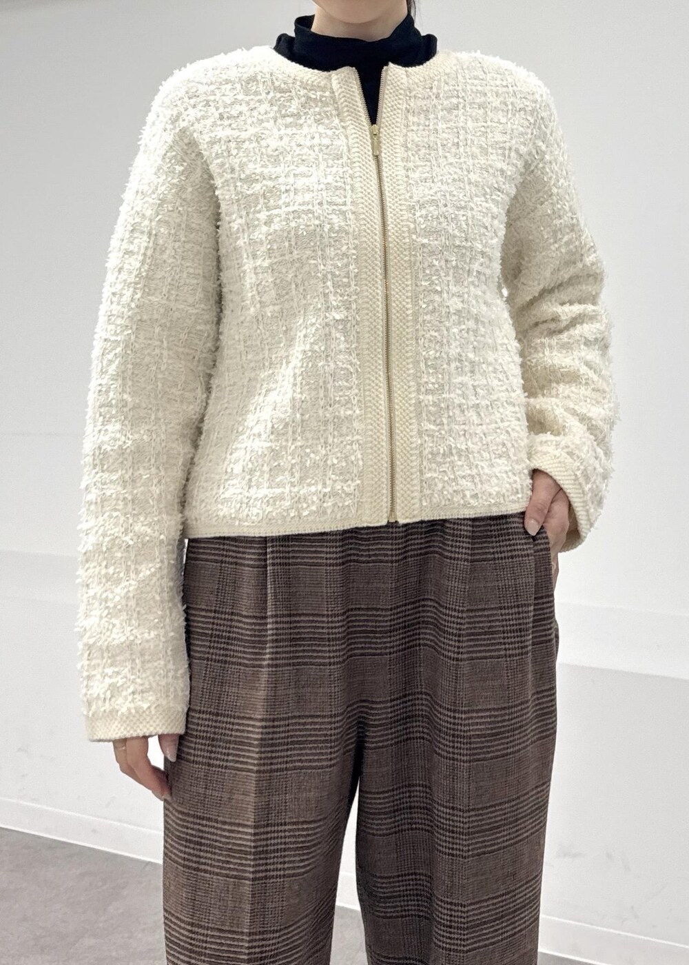 レッド系のトートバッグ、ブラウン系のブーツ、ブラック系のTシャツ/カットソーを着用したレディースの秋コーディネートの4枚目の写真