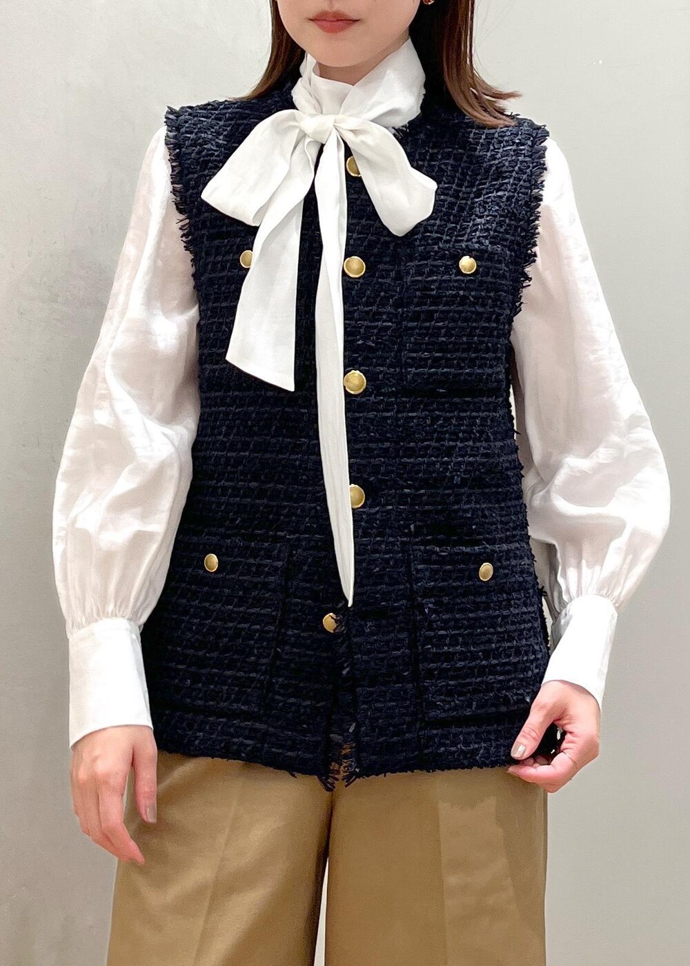 ブラック系のブーツ、ホワイト系のシャツ/ブラウス、ブルー系のベストを着用したレディースの秋コーディネートの4枚目の写真