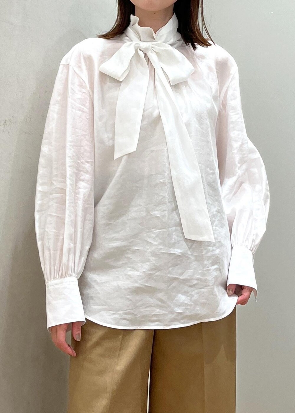 ブラック系のブーツ、ホワイト系のシャツ/ブラウス、ブルー系のベストを着用したレディースの秋コーディネートの5枚目の写真