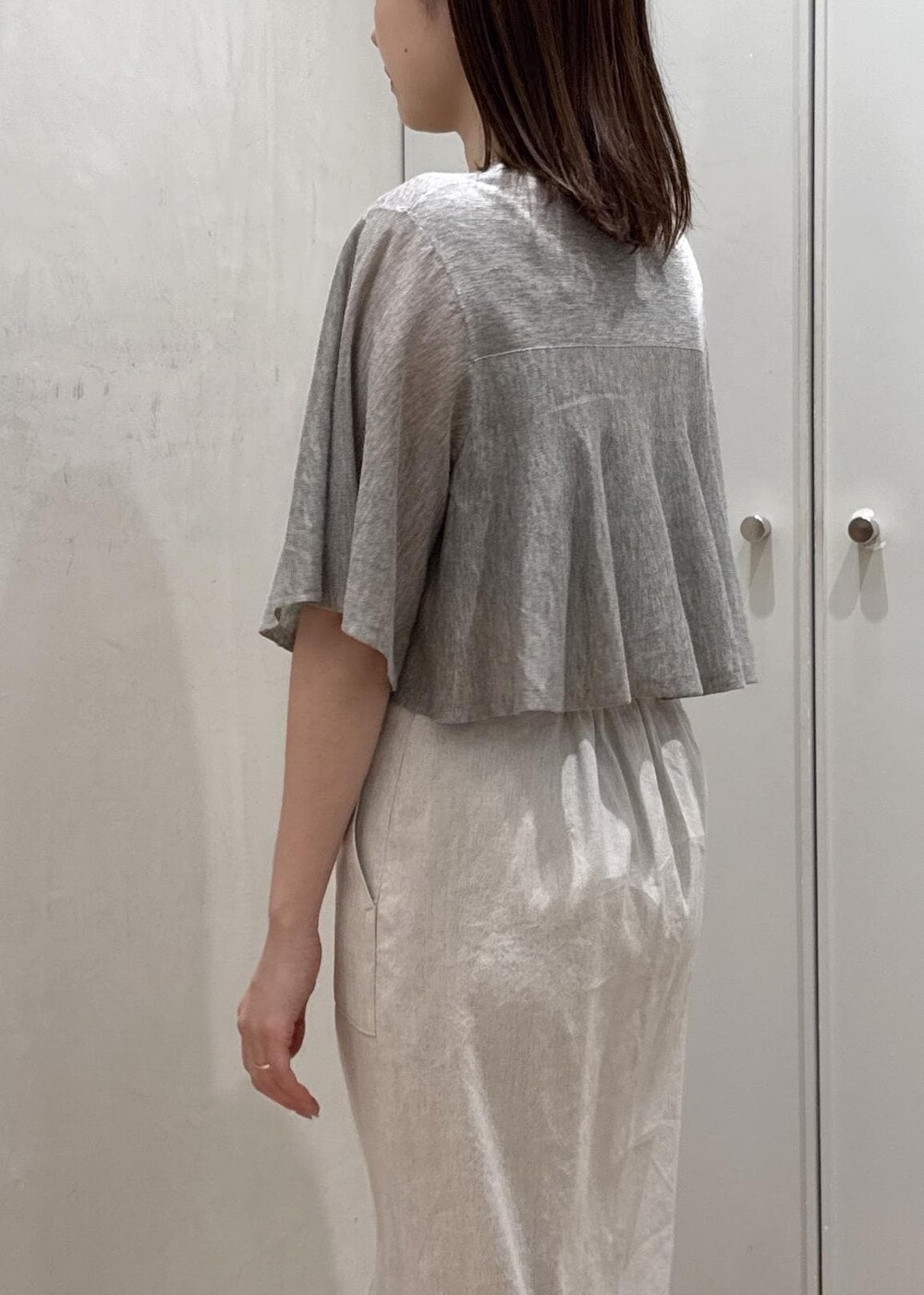 ホワイト系のハンドバッグ、ベージュ系のTシャツ/カットソー、ベージュ系のスカートを着用したレディースの夏コーディネートの6枚目の写真