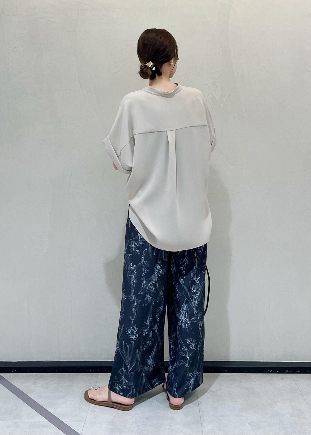 ブラック系のハンドバッグ、ベージュ系のサンダル、ベージュ系のシャツ/ブラウスを着用したレディースの夏コーディネートの3枚目の写真