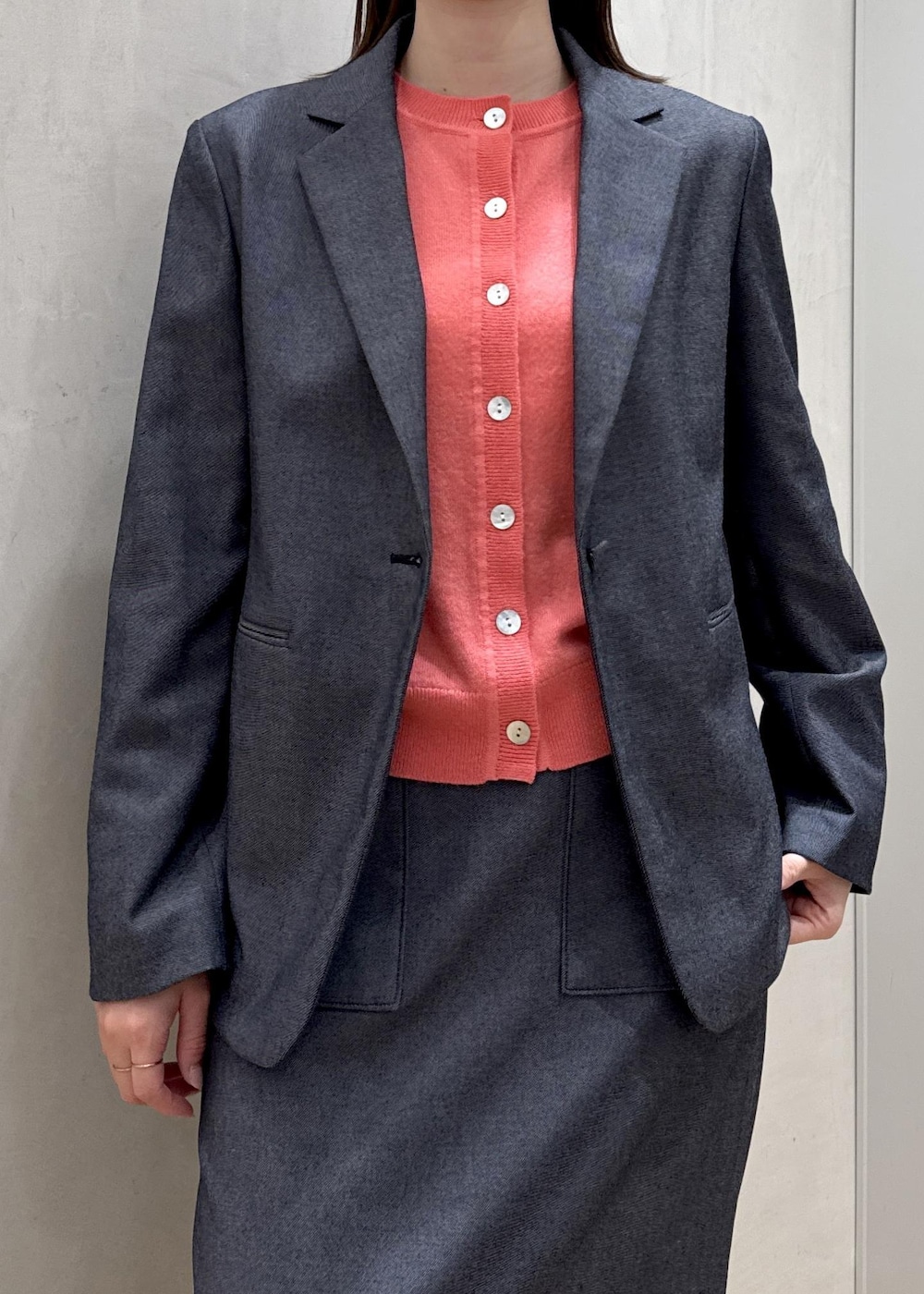 ブラック系のトートバッグ、ブルー系のテーラードジャケット、ブルー系のスカートを着用したレディースの冬コーディネートの4枚目の写真