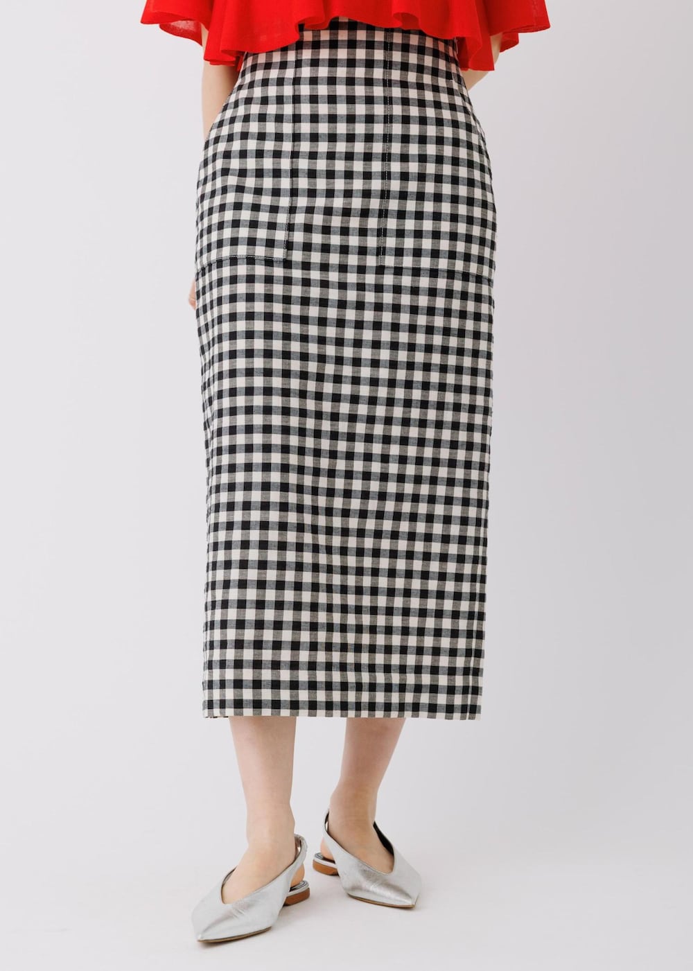 レッド系のTシャツ/カットソー、ブラック系のスカートを着用したレディースの春コーディネートの5枚目の写真