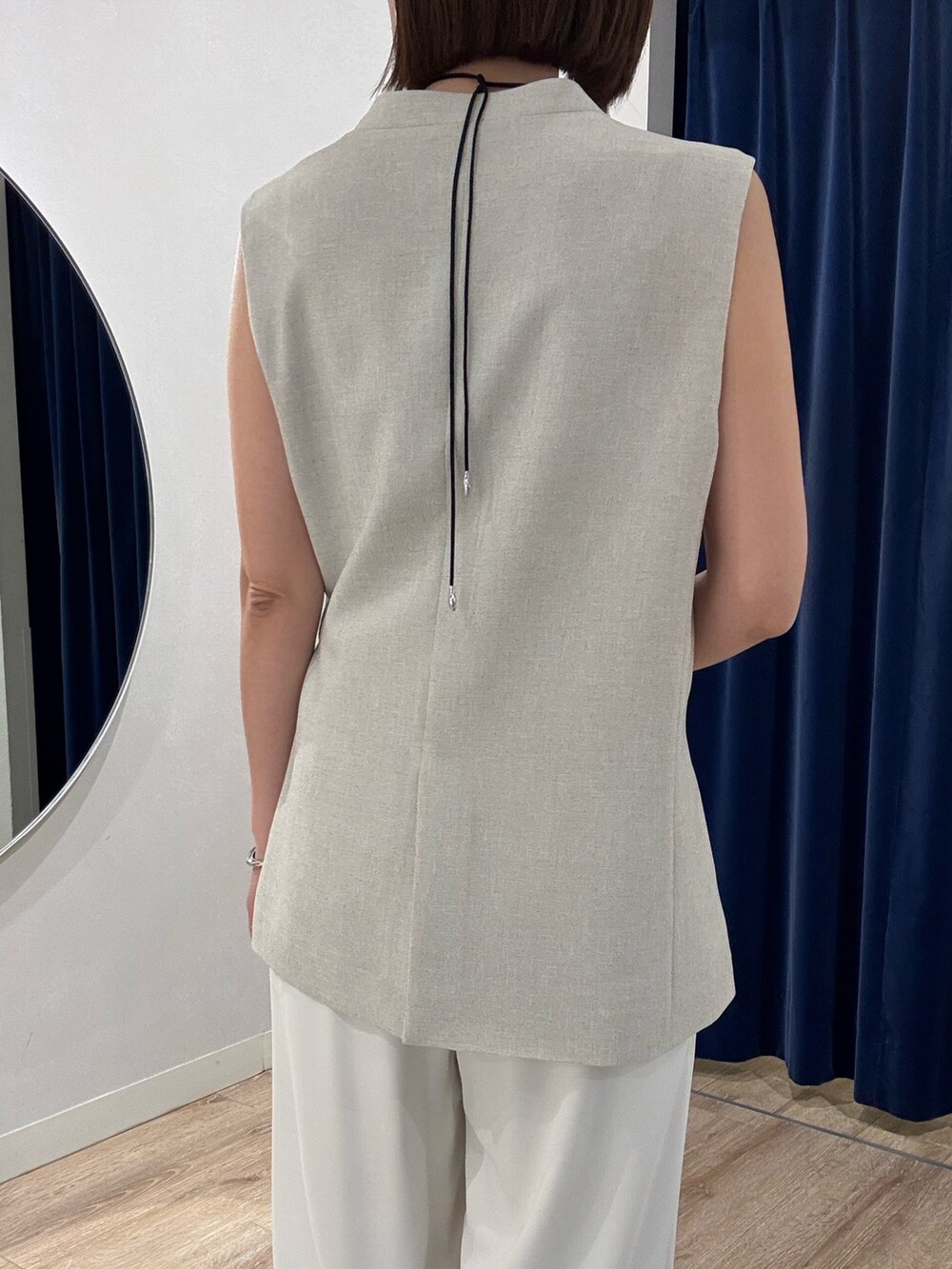 ベージュ系のベスト、ホワイト系のキャミソール、ホワイト系のその他パンツを着用したレディースの春コーディネートの9枚目の写真