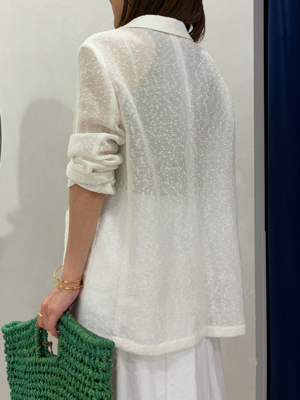 ブラウン系のタンクトップ、ホワイト系のテーラードジャケット、ホワイト系のスカートを着用したレディースの春コーディネートの9枚目の写真