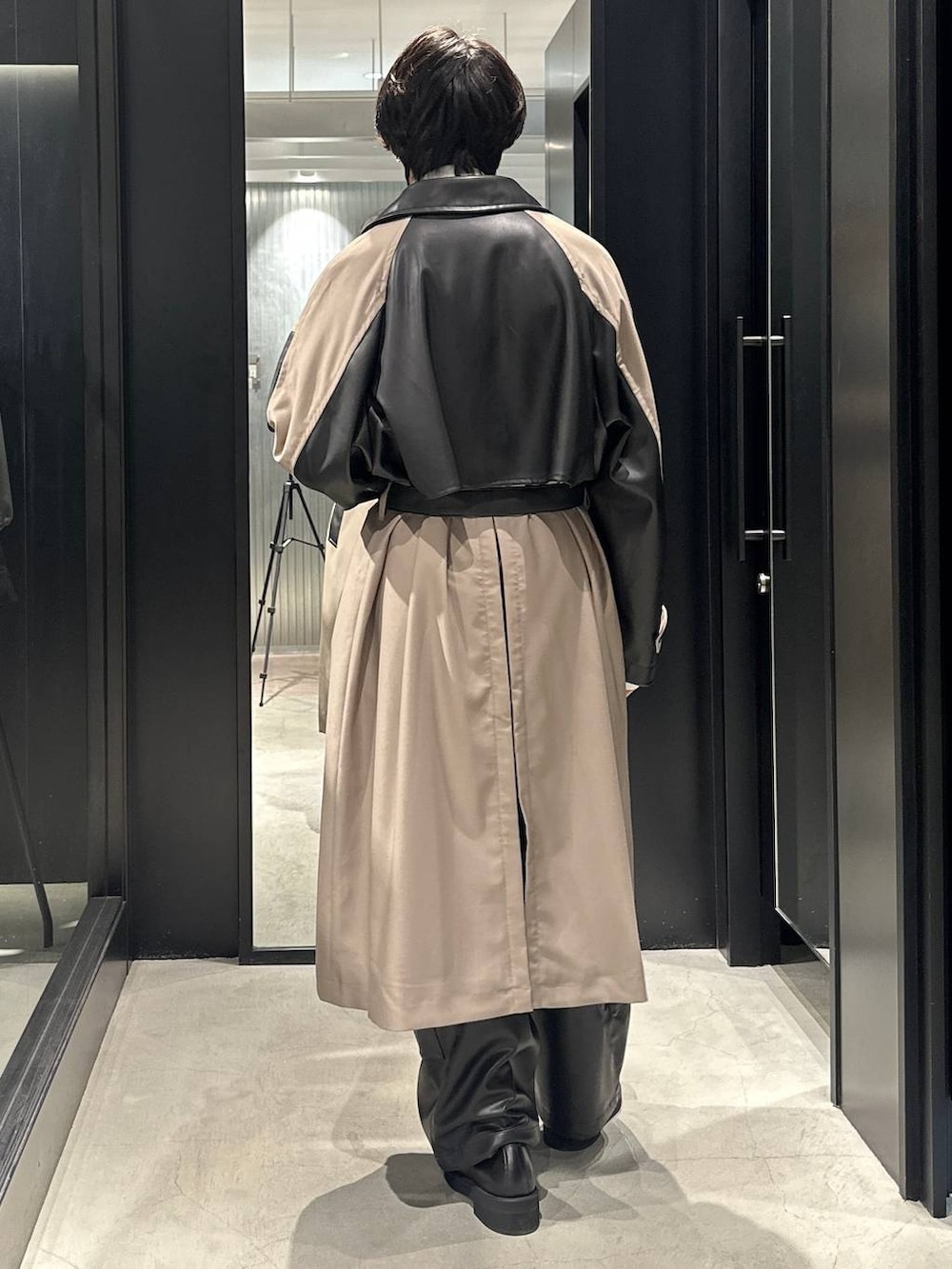 ブラック系のカーゴパンツ、ブラック系のローファー、ベージュ系のトレンチコートを着用したメンズの秋コーディネートの3枚目の写真