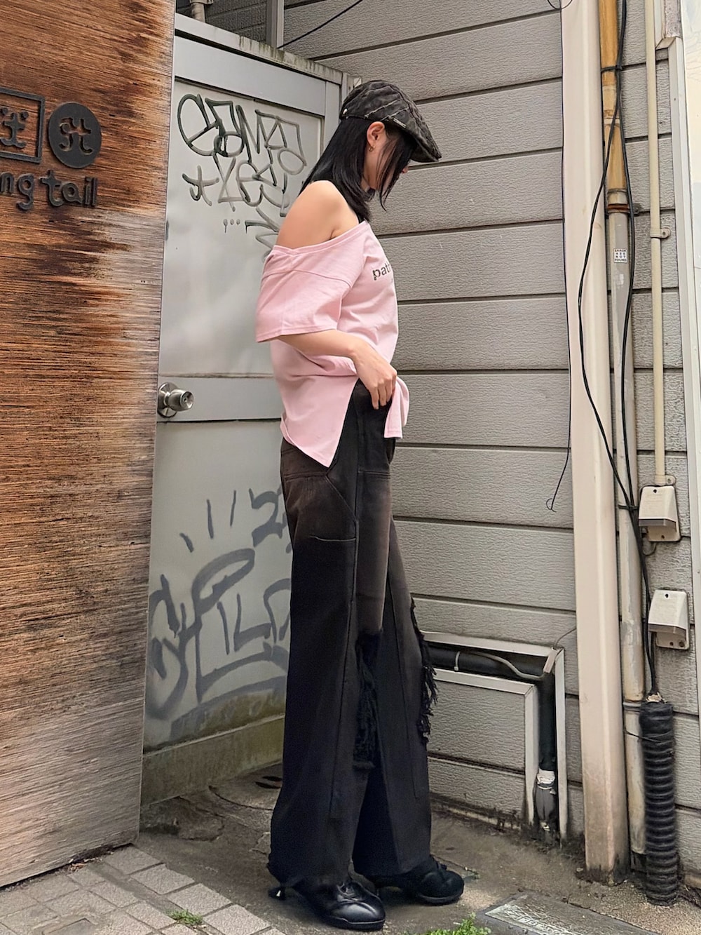 ブラック系のタンクトップ、ピンク系のTシャツ/カットソー、ブラック系のデニムパンツを着用したレディースの春コーディネートの2枚目の写真