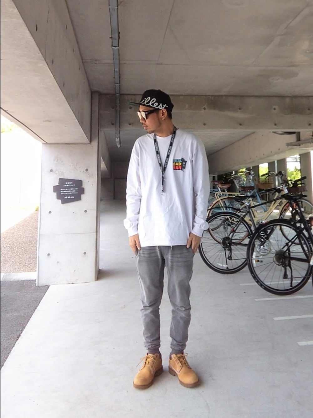 イエロー系のブーツ、ピンク系のTシャツ/カットソー、グレー系のその他パンツを着用したメンズの春コーディネートの2枚目の写真