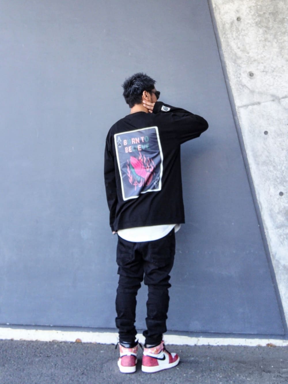 ブラック系のTシャツ/カットソー、ホワイト系のタンクトップ、ブラック系のデニムパンツを着用したメンズの春コーディネートの2枚目の写真