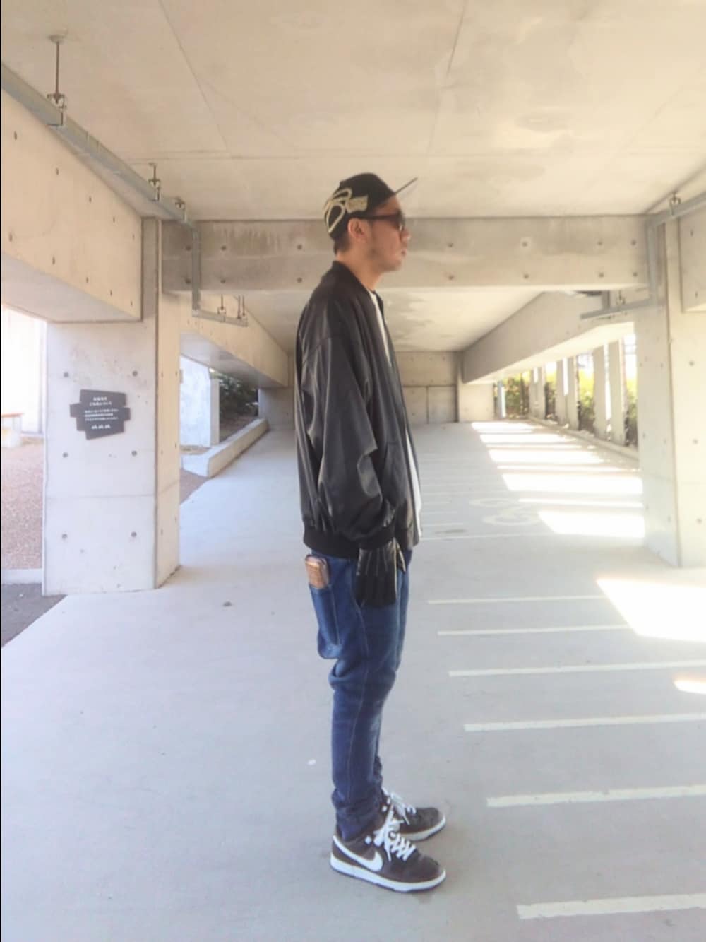 ブラック系のジャケット/アウター、ホワイト系のスウェット、ブルー系のパンツを着用したメンズの冬コーディネートの2枚目の写真