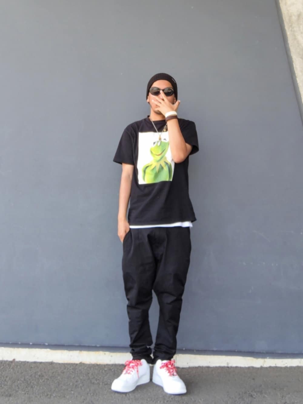 ブラック系のTシャツ/カットソー、ブラック系のその他パンツ、ホワイト系のスニーカーを着用したメンズの夏コーディネートの2枚目の写真