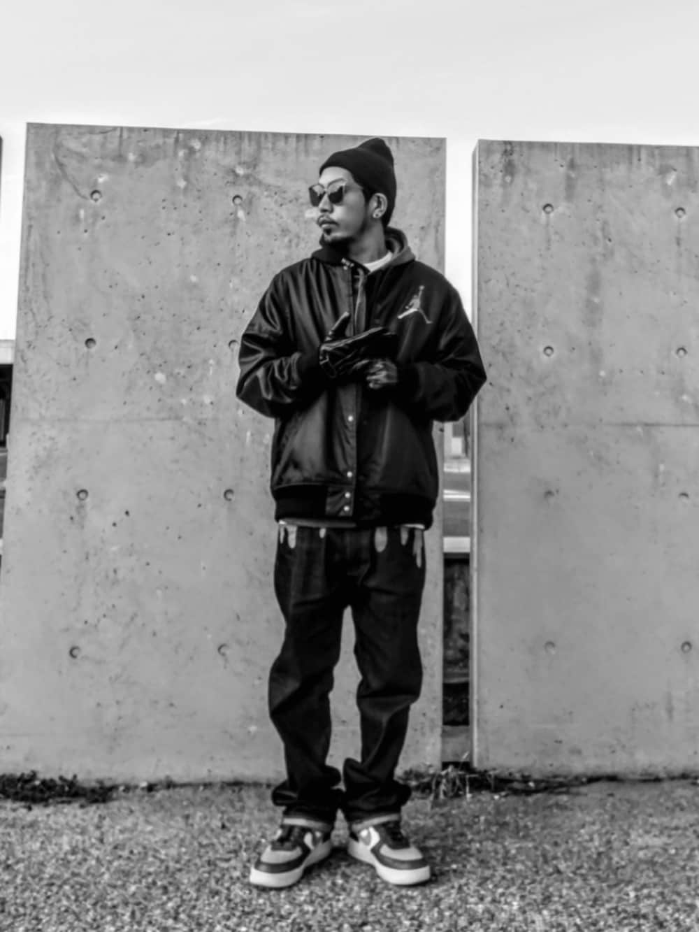 ブラック系のジャケット/アウター、ブラック系のパーカー、ブルー系のデニムパンツを着用したメンズの冬コーディネートの2枚目の写真