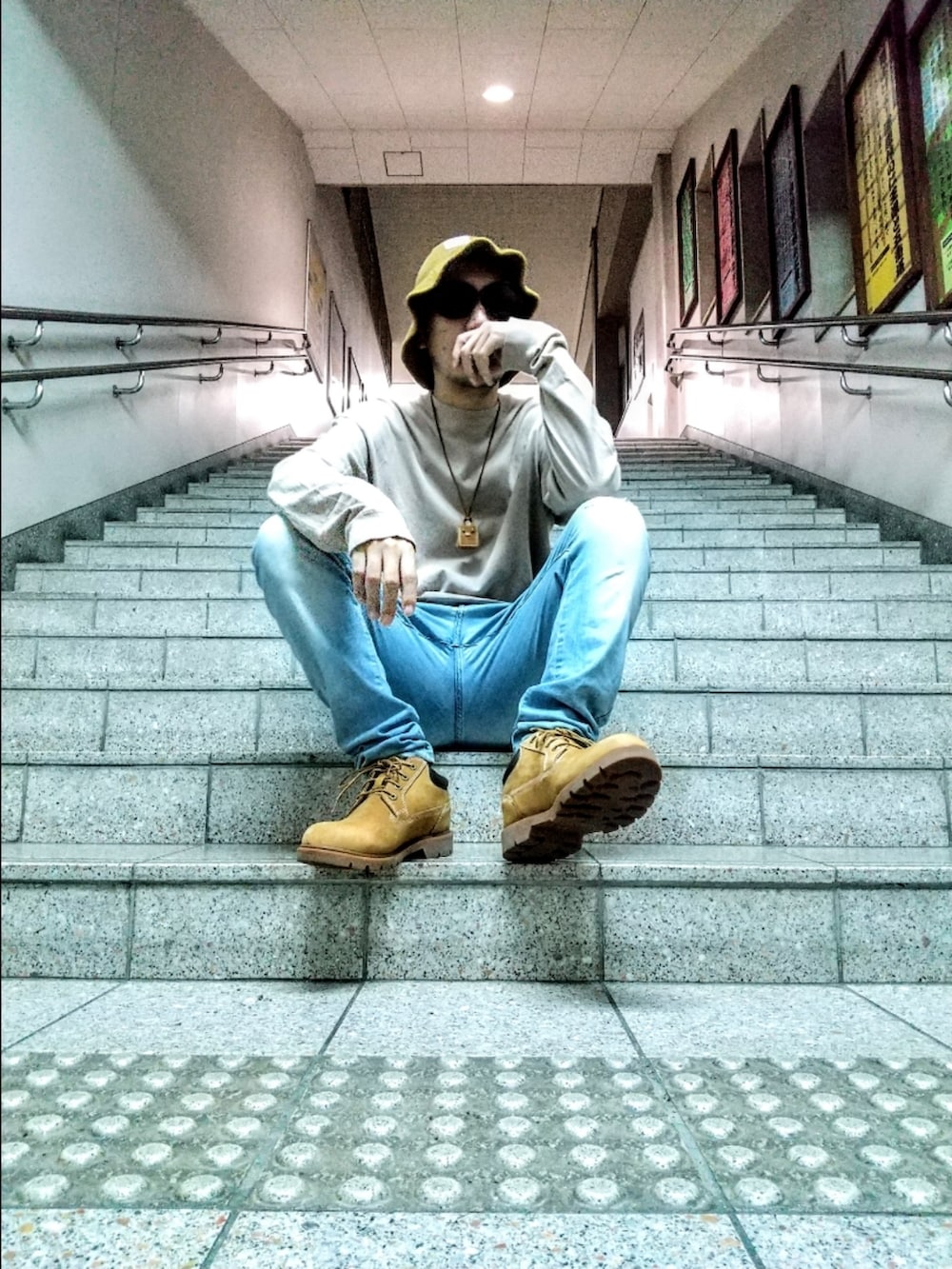 ベージュ系のTシャツ/カットソー、ブルー系のデニムパンツ、イエロー系のブーツを着用したメンズの秋コーディネートの2枚目の写真