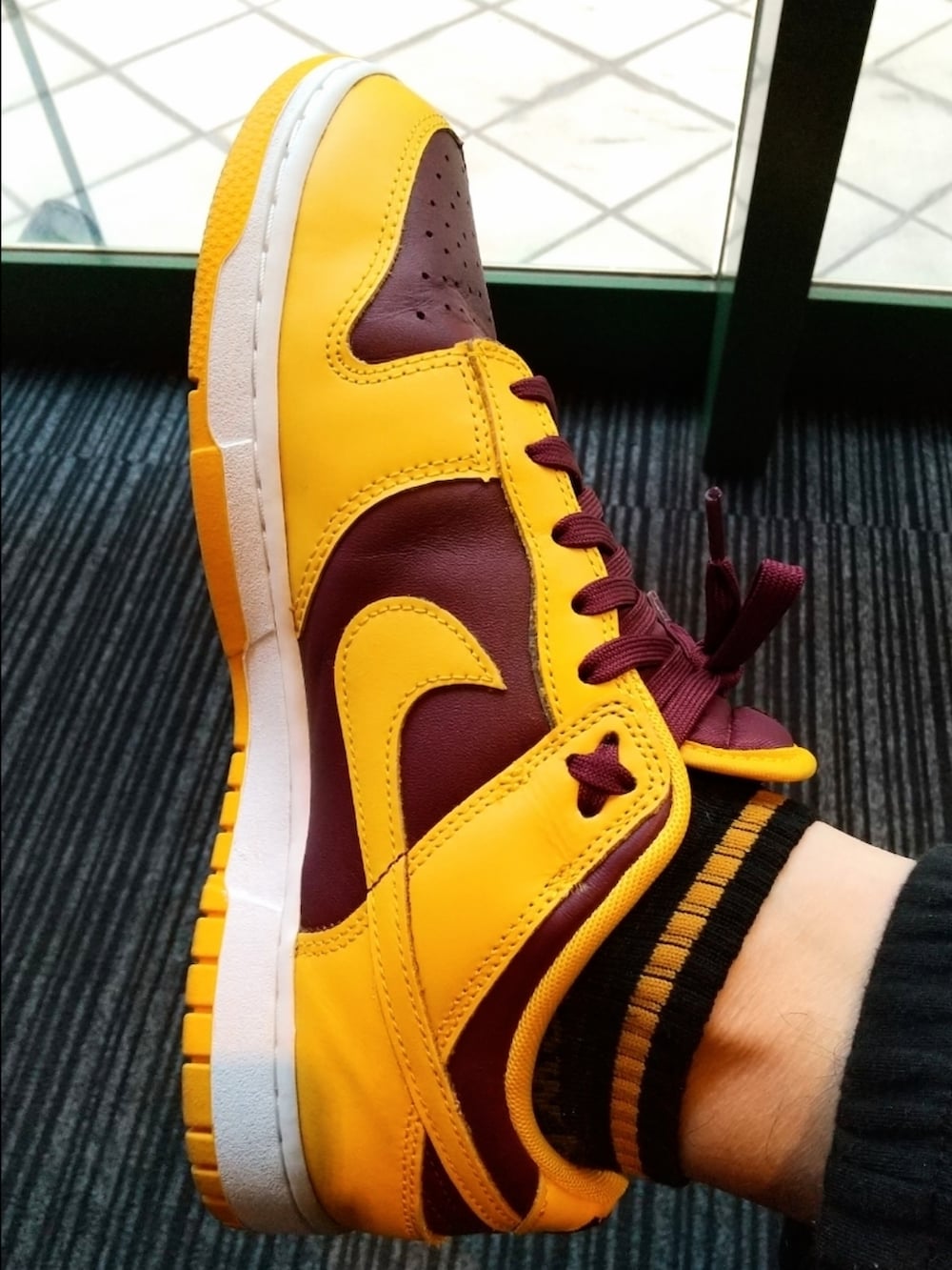 ブラウン系のスウェット、オレンジ系のTシャツ/カットソー、ブラック系のスウェットパンツを着用したメンズの春コーディネートの3枚目の写真